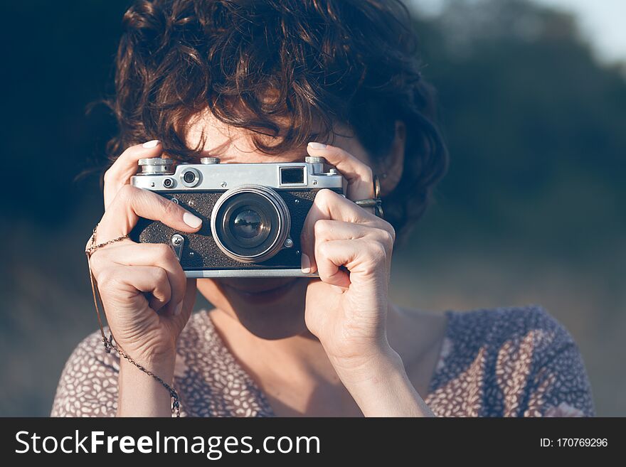 Portrait of a beautiful smiling girl with retro camera. Happy lifestyle. Portrait of a beautiful smiling girl with retro camera. Happy lifestyle