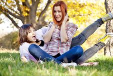 Two Beautiful Girlfriends At The Autumn Park Royalty Free Stock Photography