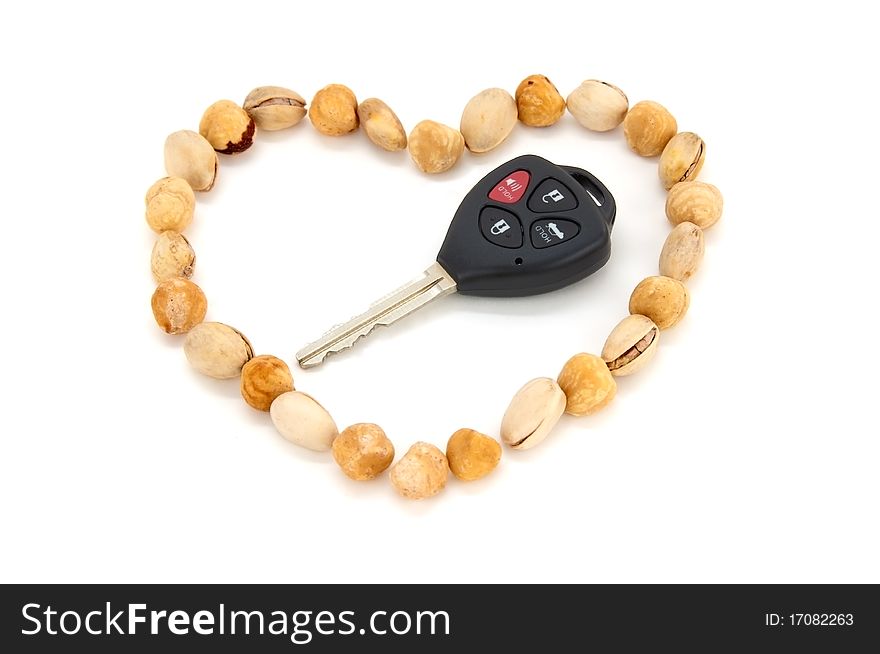 Nuts shaped into a heart as a symbol of how much of eating nuts would benefit the heart and the body. and A car's key as a gift. So you can now win the heart of your partner by good nutrition and a good gift. Nuts shaped into a heart as a symbol of how much of eating nuts would benefit the heart and the body. and A car's key as a gift. So you can now win the heart of your partner by good nutrition and a good gift.