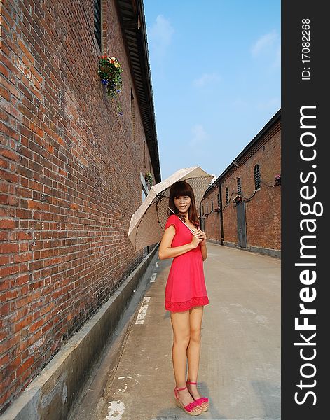 fashion girl with red dress outside the storehouse. fashion girl with red dress outside the storehouse.