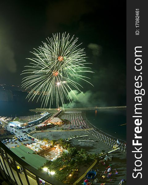 Green firework with Sorrento (Italy) landscape during annual firework contest. Green firework with Sorrento (Italy) landscape during annual firework contest