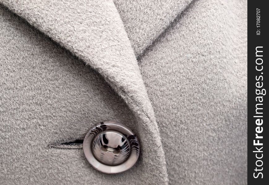Grey button on the coat