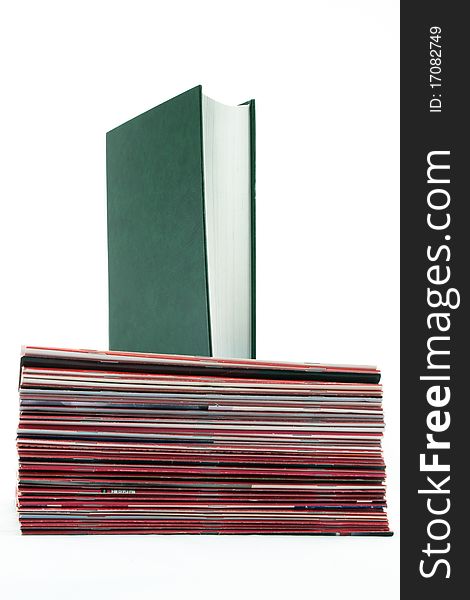 Standing book over a Pile of Magazines on a white background. Standing book over a Pile of Magazines on a white background