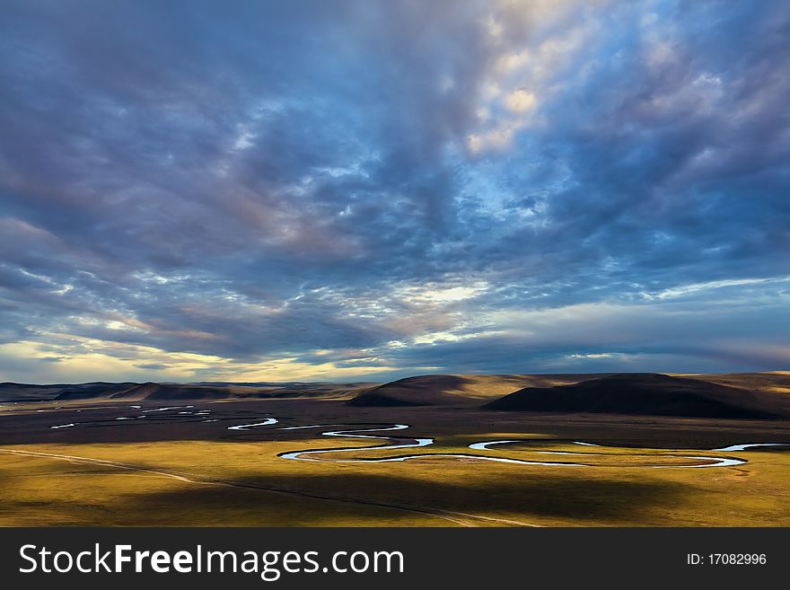 Stream between pastures and sky. Stream between pastures and sky