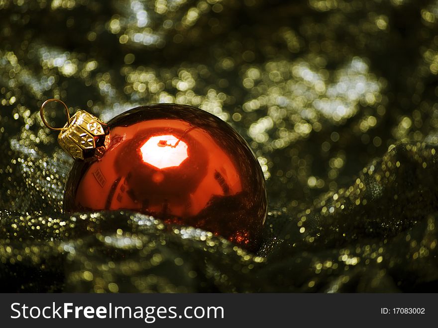 Red Christmas ball on the sheer black material. Red Christmas ball on the sheer black material