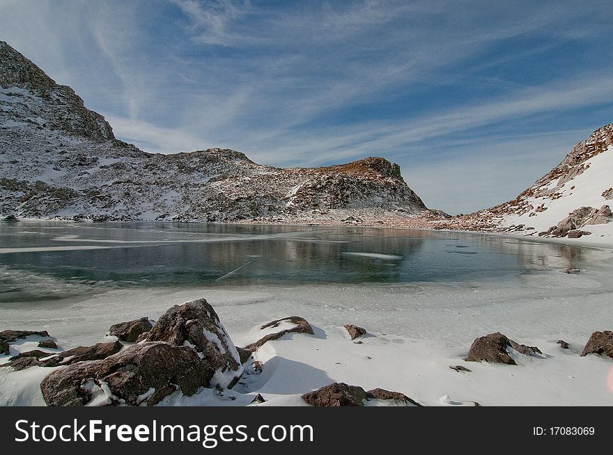 Frozen high alpine lake in Julian Alps