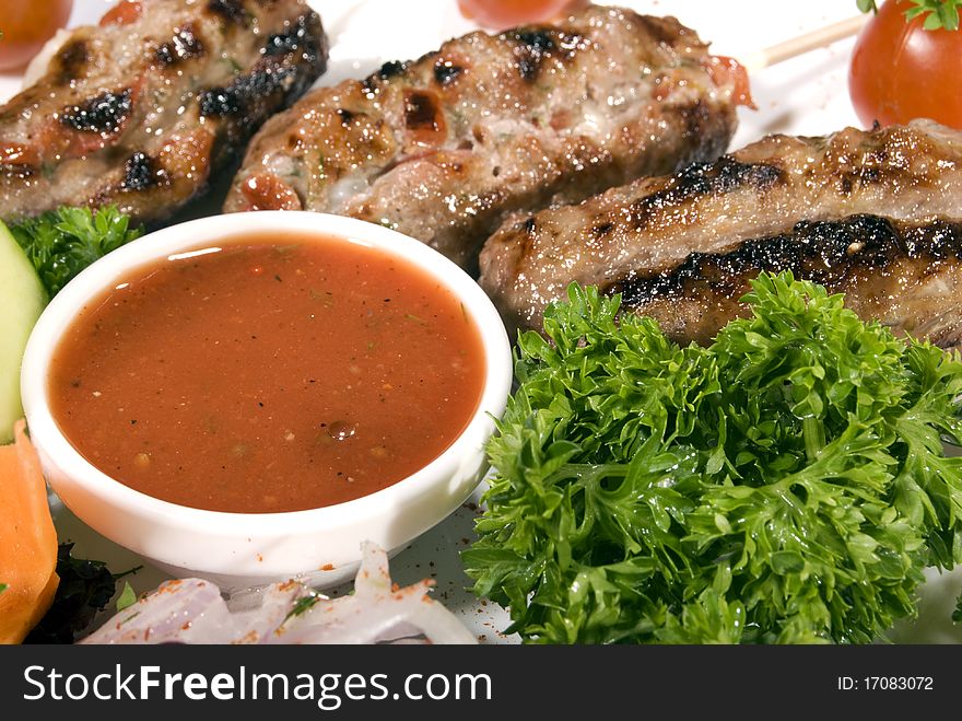 Fried meat served with tomato sauce and salad