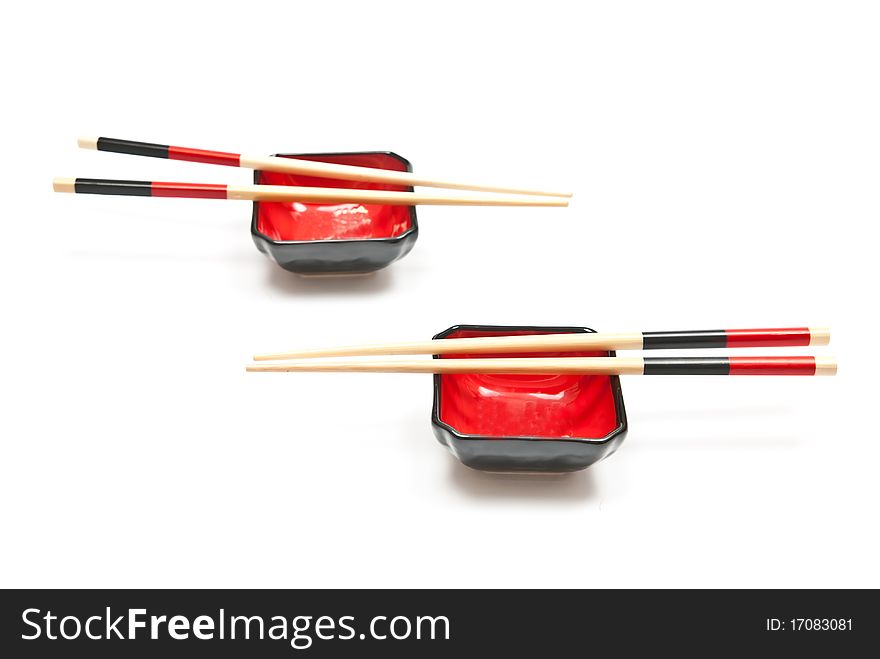 Black and red sushi set (chopsticks and plate) isolated on white background. Black and red sushi set (chopsticks and plate) isolated on white background