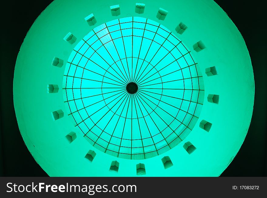 A dome inside a mosque turn into green color reflected by the transparent green material at top the dome. A dome inside a mosque turn into green color reflected by the transparent green material at top the dome.