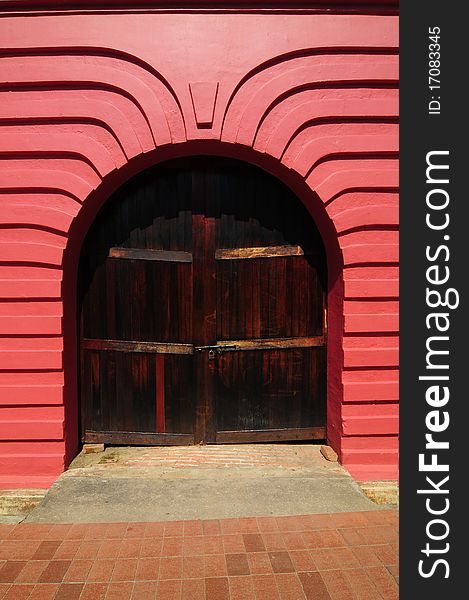 An old beautiful red arch with door at Melaka. An old beautiful red arch with door at Melaka.