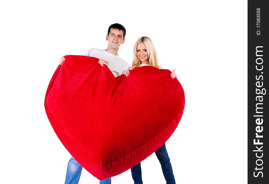 Young couple with a big heart on white background