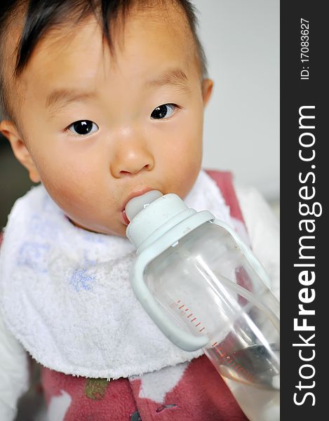 A old Asian baby boy drinking bottle milk. A old Asian baby boy drinking bottle milk