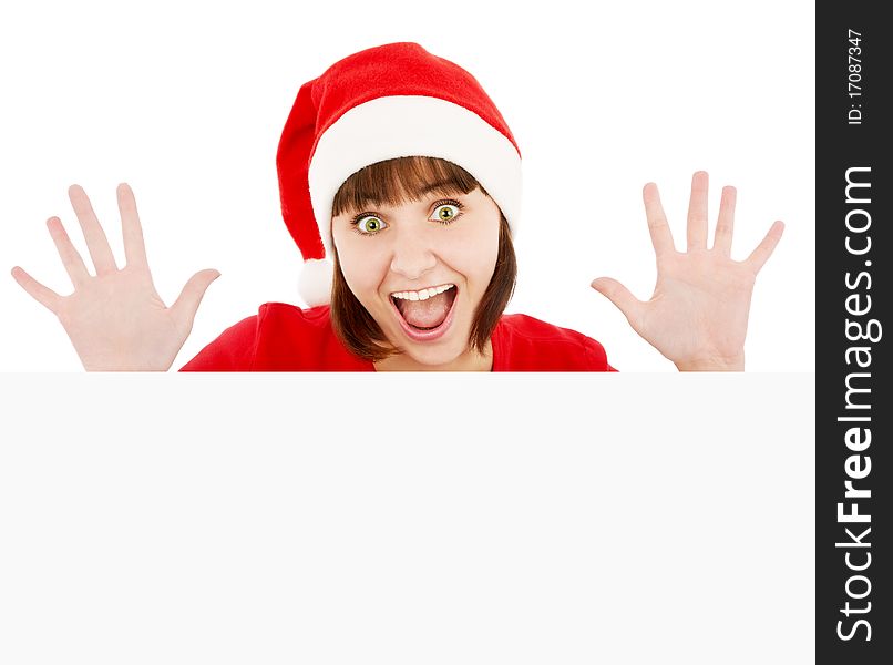 Surprised woman in Santa red hat peeking from blank billboard, isolated on white. Surprised woman in Santa red hat peeking from blank billboard, isolated on white
