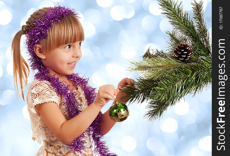 Little girl decorating artificial christmas firtree. Little girl decorating artificial christmas firtree