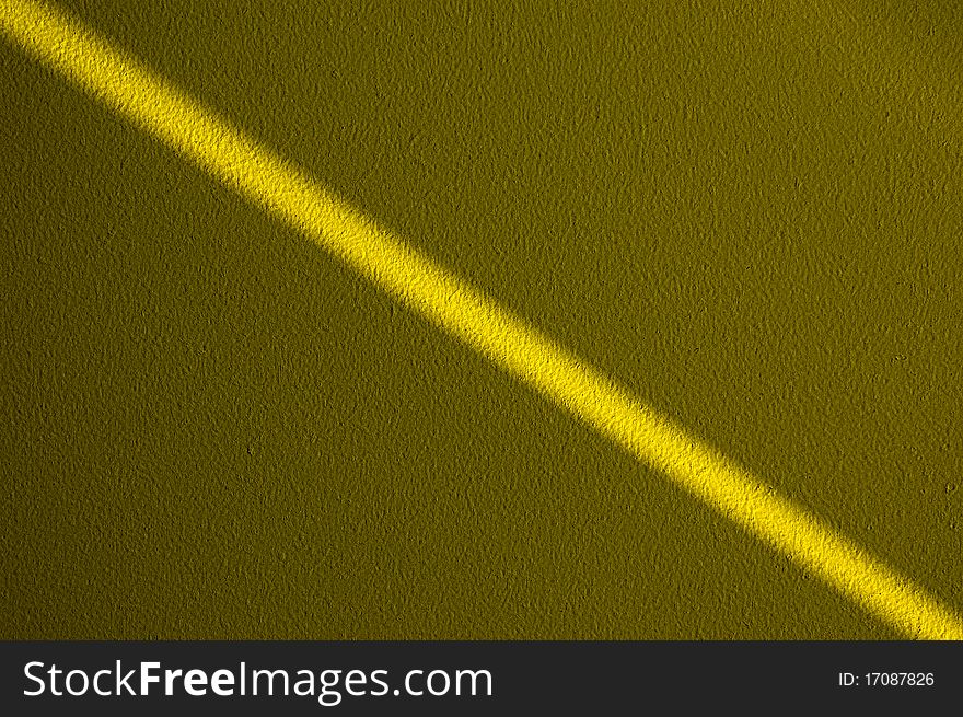 Ray of light on a yellow wall