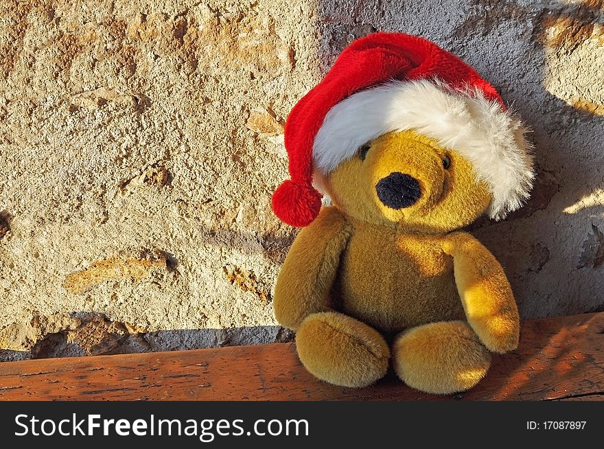 Teddy bear sitting position and wearing a cap Christmas. Teddy bear sitting position and wearing a cap Christmas