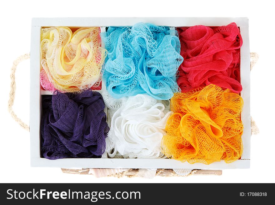 Wooden box and colour sponges on white background