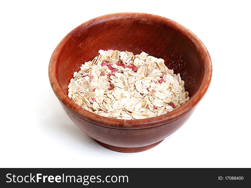 Wooden plate with flakes on white background