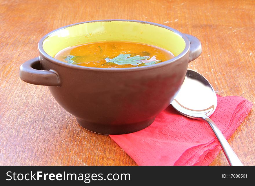 Fresh vegetable soup on wooden table