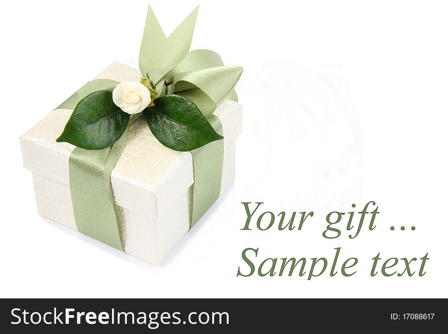 Gift box with green ribbon and a rose isolated on a white background