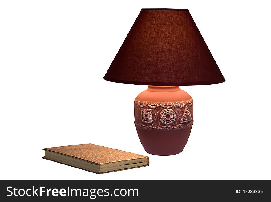 The book lies under a lamp and is shined by warm light. The book lies under a lamp and is shined by warm light