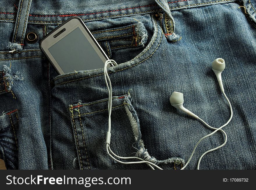 Mp3 player and  Mobile Phone  in a biue jeans pocket
