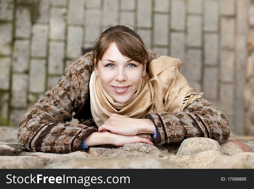 Young woman near the gray stone wall. Young woman near the gray stone wall