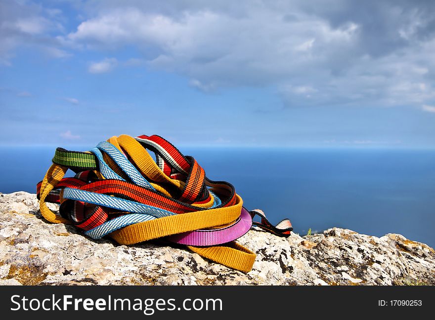 Colored ropes on the rock against the blue sky