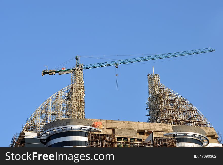 Construction Site with crane against blue sky