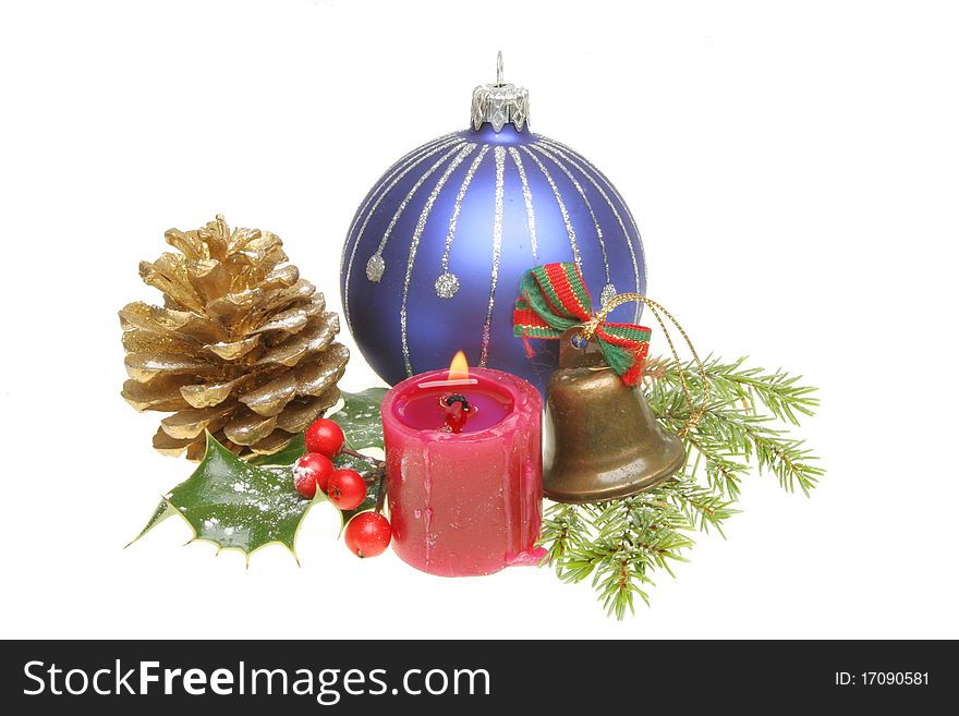 Christmas ornaments and snow dusted seasonal foliage with a burning candle. Christmas ornaments and snow dusted seasonal foliage with a burning candle