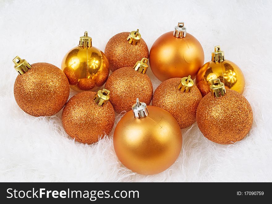 Christmas golden orange spheres on a white fur