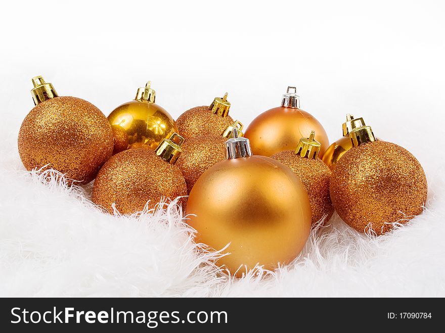 Golden orange spheres on a white fur