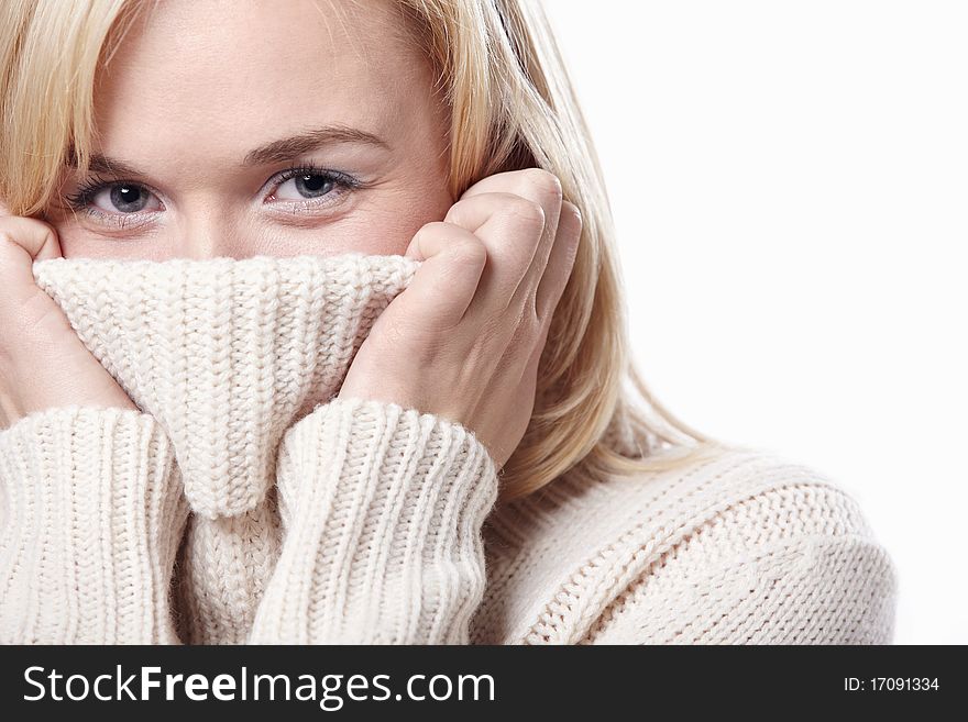 Attractive girl closes sweater face. Attractive girl closes sweater face