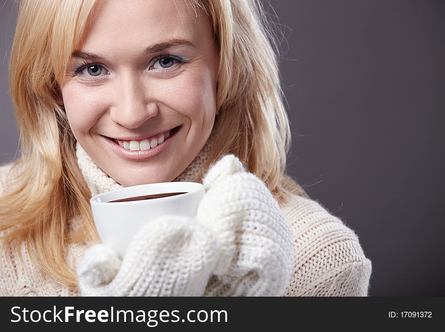 Attractive girl with a cup of mittens