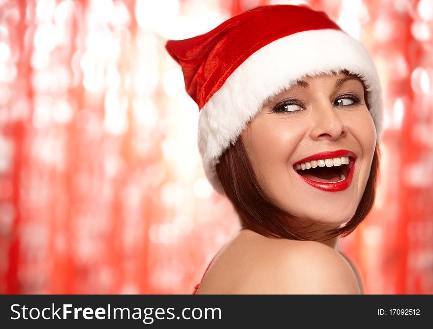 Portrait of a beautiful and woman wearing santa claus hat isolated on red. Portrait of a beautiful and woman wearing santa claus hat isolated on red