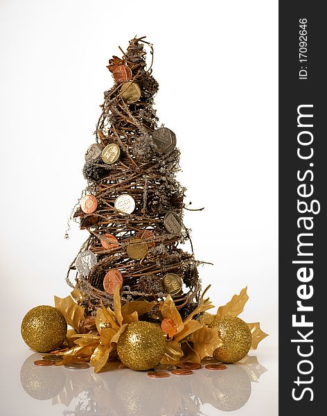 A vertical image of a willow christmas terr with coins as decorations to suggest money doesn't grow on trees concept. A vertical image of a willow christmas terr with coins as decorations to suggest money doesn't grow on trees concept