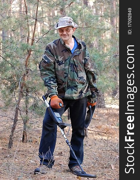 Military archeology. Man with metal detector on the battlefield of WW2.Ukraine