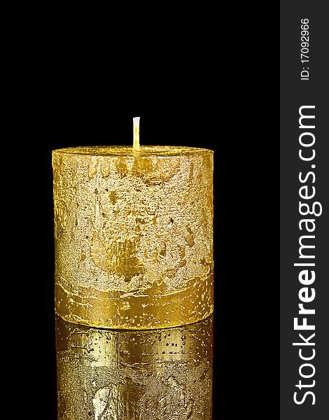 Candle gold on a black reflective background. Candle gold on a black reflective background.