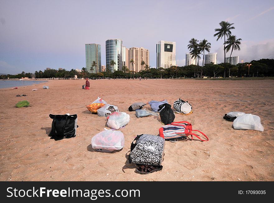 Many Bags On A Sandy Beach With Buildings