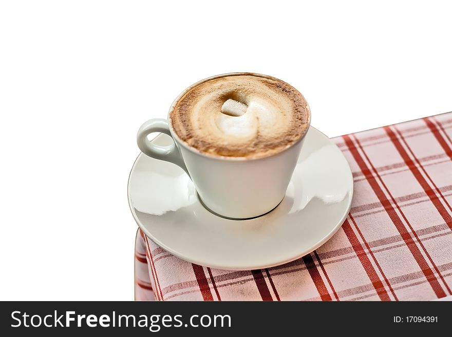 Coffee (cappuccino) with sugar on a corner of a table