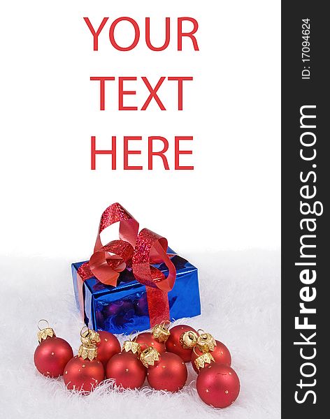 Christmas card with red spheres and blue box on the white fur