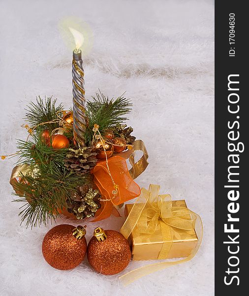 Christmas silver candles and golden box on the white skin