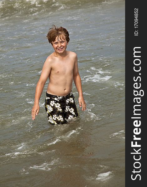 Cute Boy Enyoys The Water In The Ocean