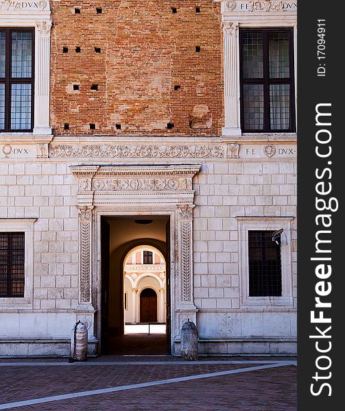 The imposing Palazzo Ducale in Urbino and its main door. The imposing Palazzo Ducale in Urbino and its main door