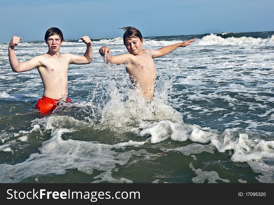 Boys have fun in the beautiful ocean with waves. Boys have fun in the beautiful ocean with waves