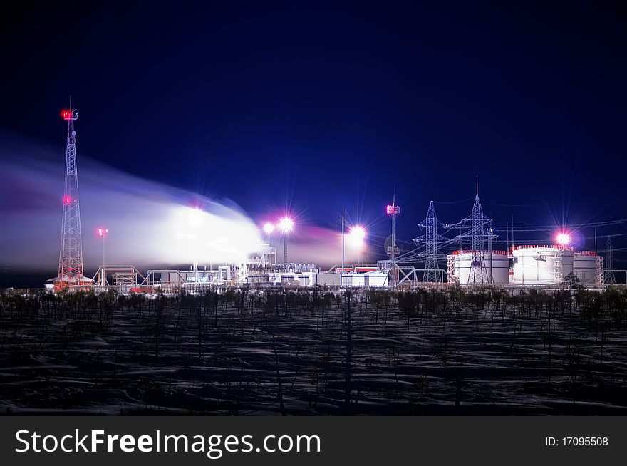 Night view of the refinery.  smoke plume in the winter sky in Western Siberia. Night view of the refinery.  smoke plume in the winter sky in Western Siberia.