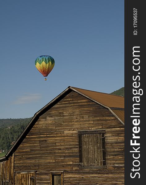 A hot air balloon rises into the skies above an old barn in Steamboat Springs, Colorado. A hot air balloon rises into the skies above an old barn in Steamboat Springs, Colorado