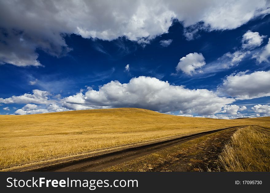 Rural landscape. Road, meadow, the sky and cloudsã€‚. Rural landscape. Road, meadow, the sky and cloudsã€‚