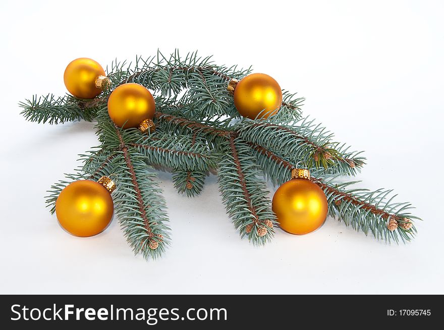 Center piece made of single branch of evergreen decorated with yellow ornaments on white, isolating background. Center piece made of single branch of evergreen decorated with yellow ornaments on white, isolating background