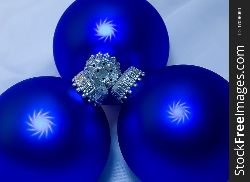 Three blue Christmas balls with silver caps and white swirly dots. Three blue Christmas balls with silver caps and white swirly dots